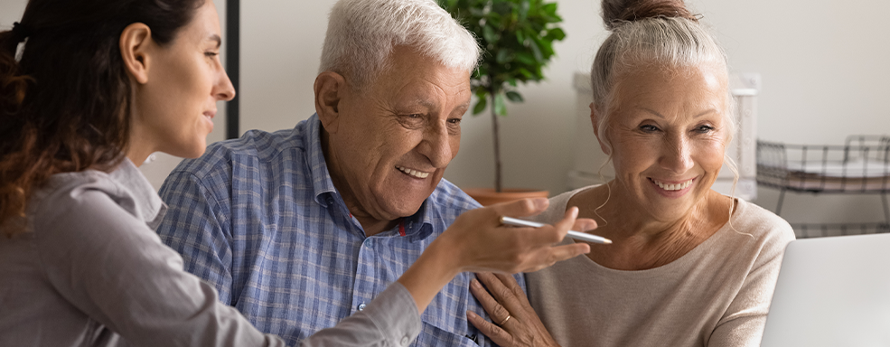 Image of medicare provided counselor with senior couple as patients.